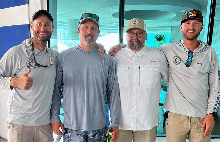 Mason Tush (far left)with his arm on Tarpon Tournament Winner Doug Forde's shoulder.